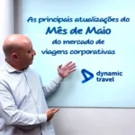 Demetrius apontando para lousa escrito: as principais atualizações do mês de maio sobre o mercado de viagens corporativas
